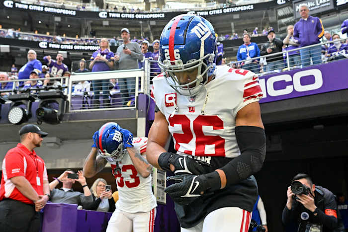 Jan 15, 2023; Minneapolis, Minnesota, USA; New York Giants running back Saquon Barkley (26) runs onto the field before a wild card game against the Minnesota Vikings at U.S. Bank Stadium.